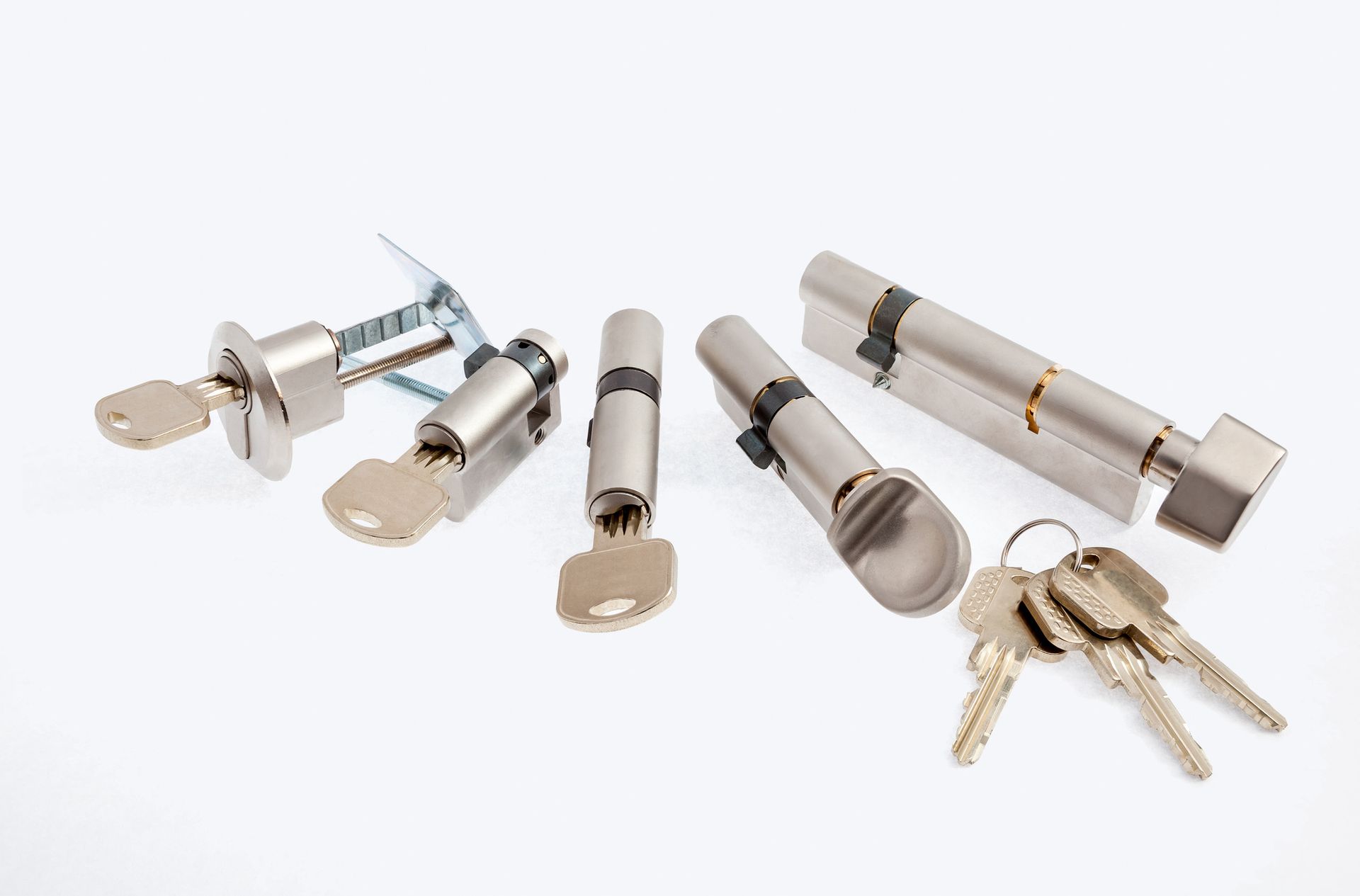 There are many different types of locks and keys on a white background.