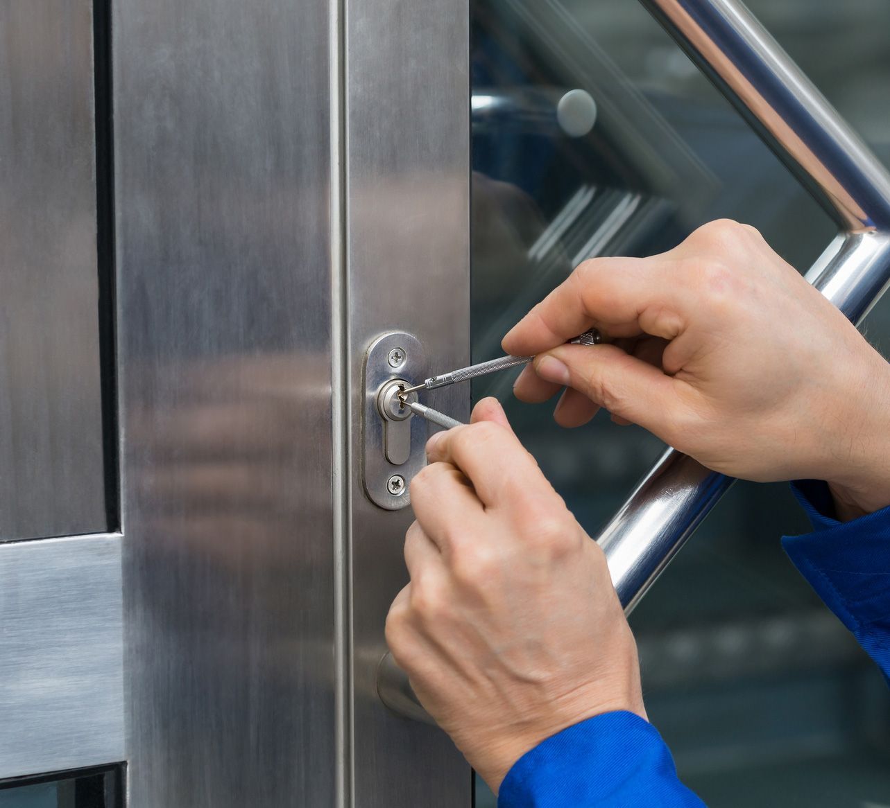 A person is using a key to open a door