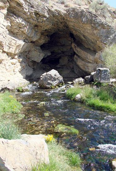 A stream running through a cave in the mountains.