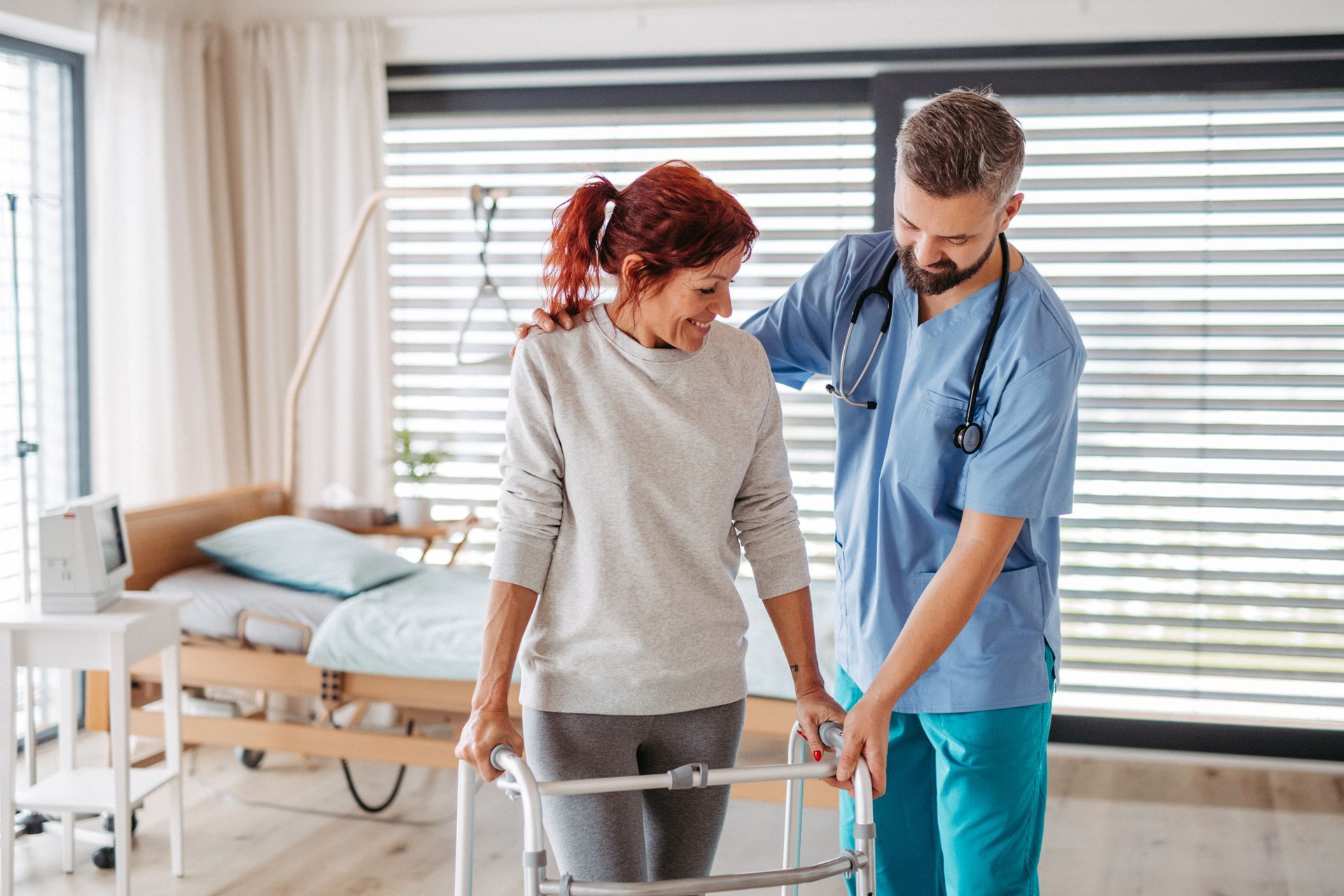 Female patient with mobility walker and her physiotherapist.