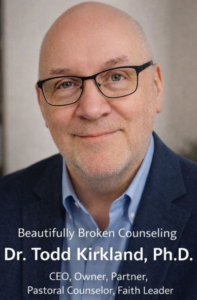 A close up of a man wearing glasses and a beard.