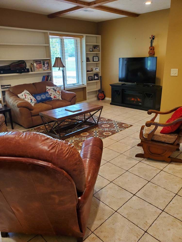 A living room filled with furniture and a flat screen tv.