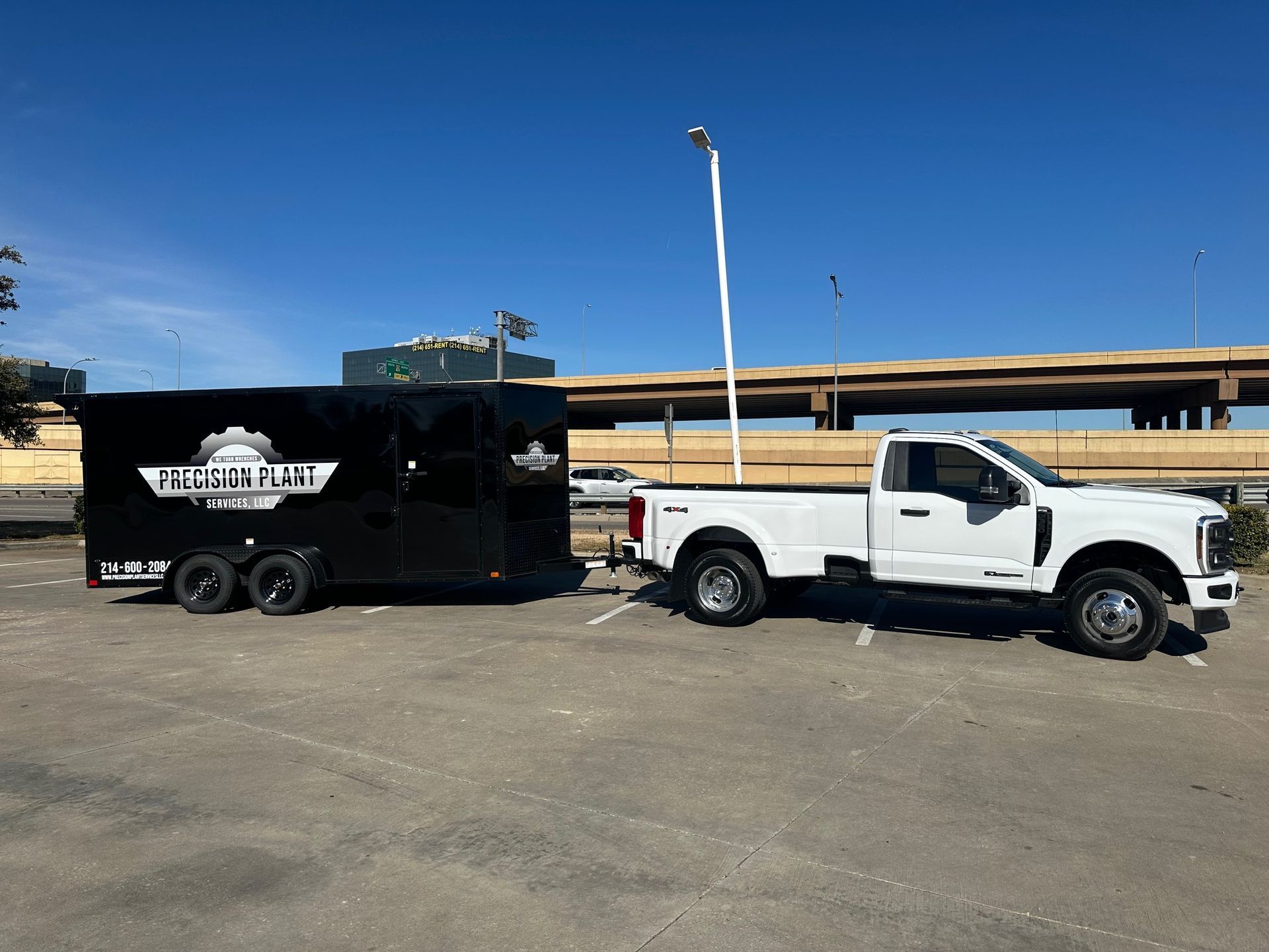 White pickup truck towing a black trailer