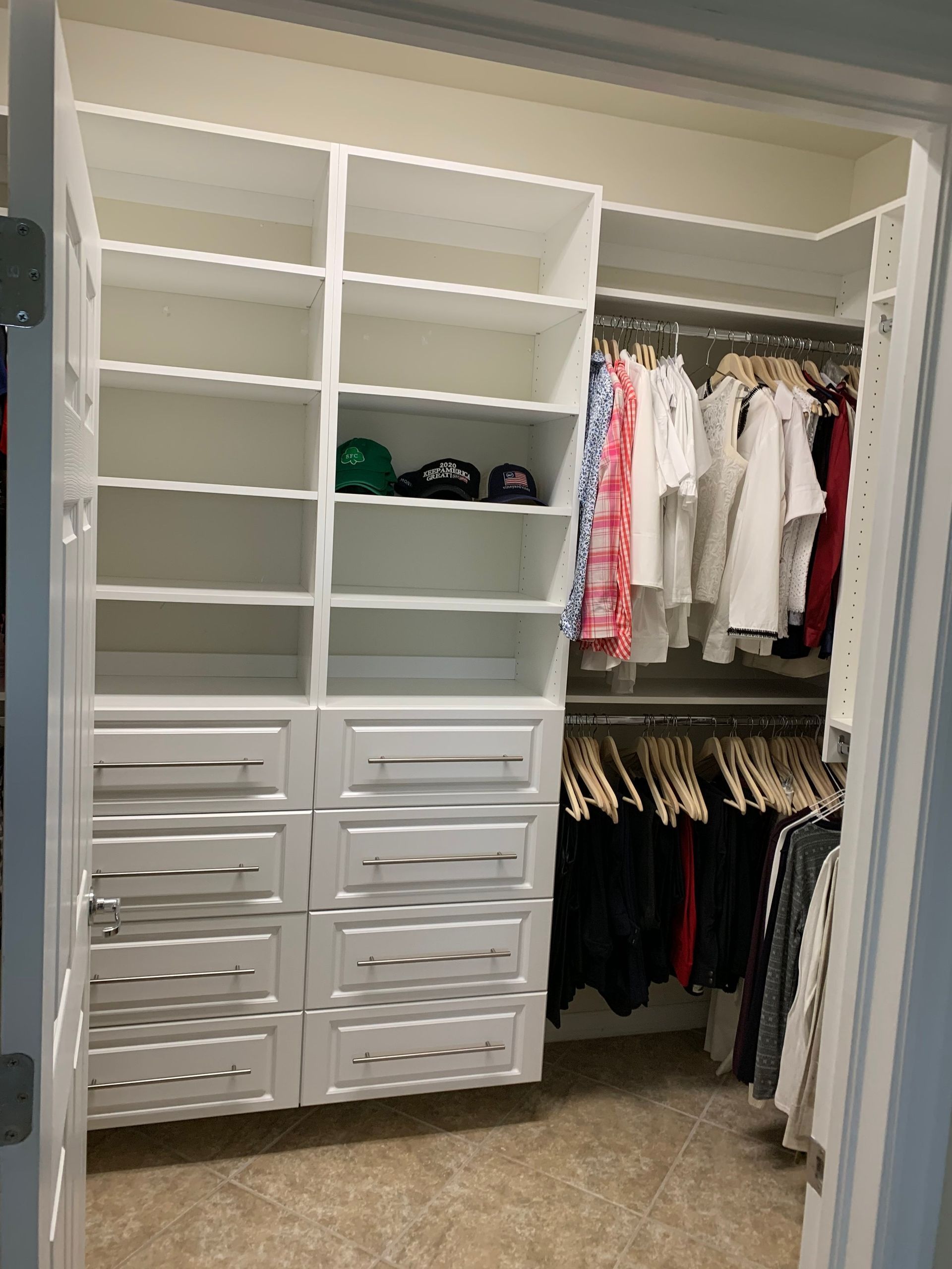 A walk in closet filled with lots of clothes and hats.