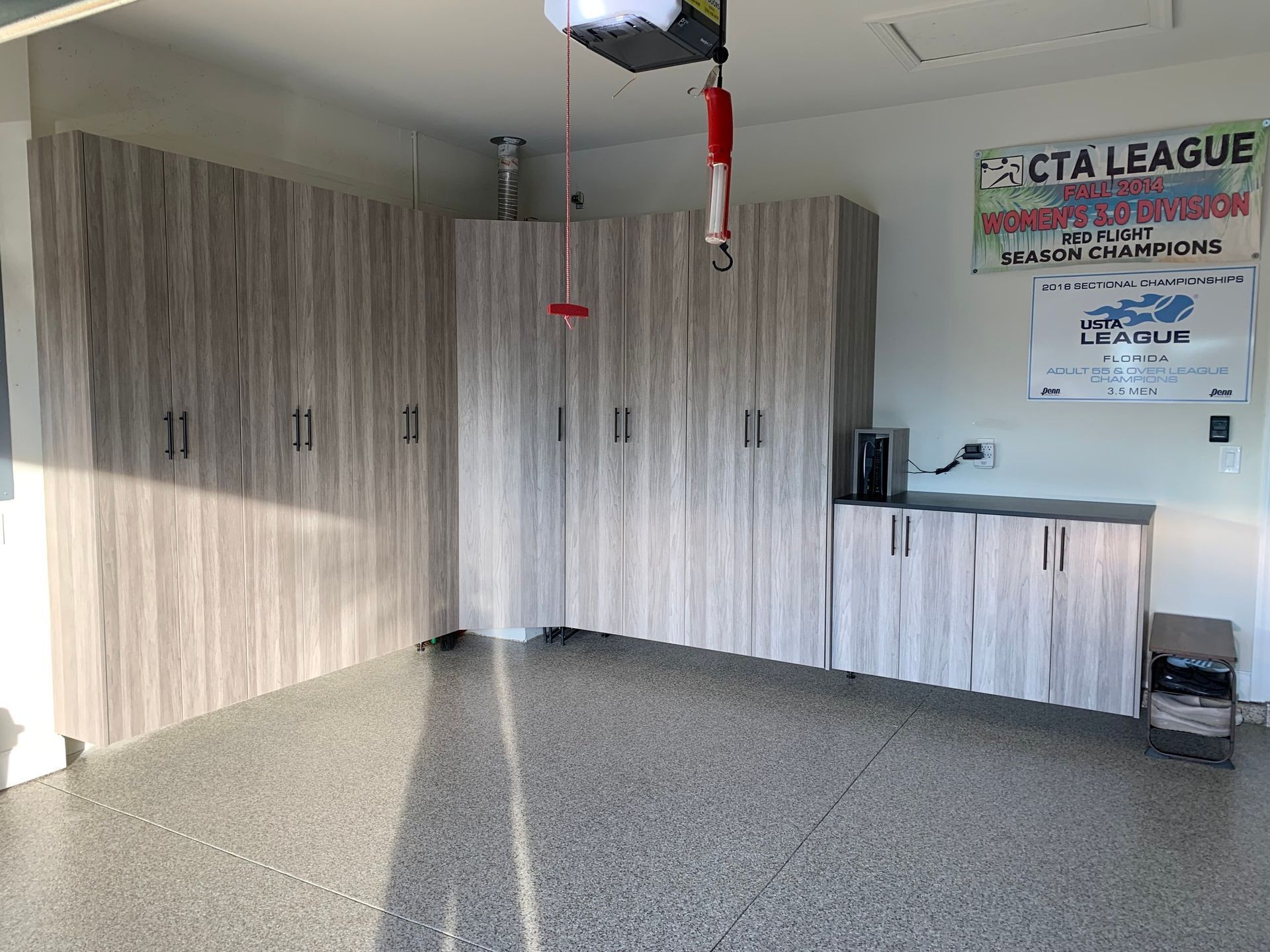 A garage with a lot of cabinets and a sign on the wall.
