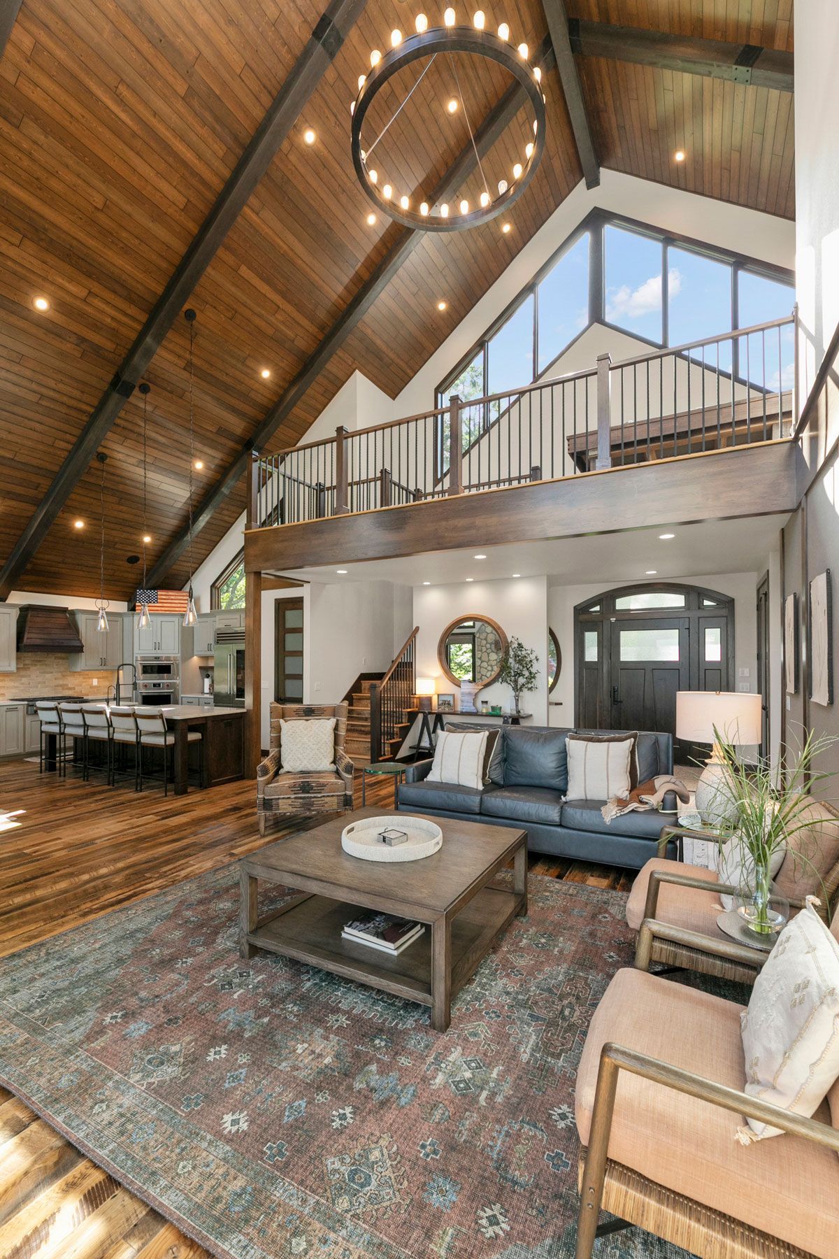 A living room filled with furniture and a vaulted ceiling.