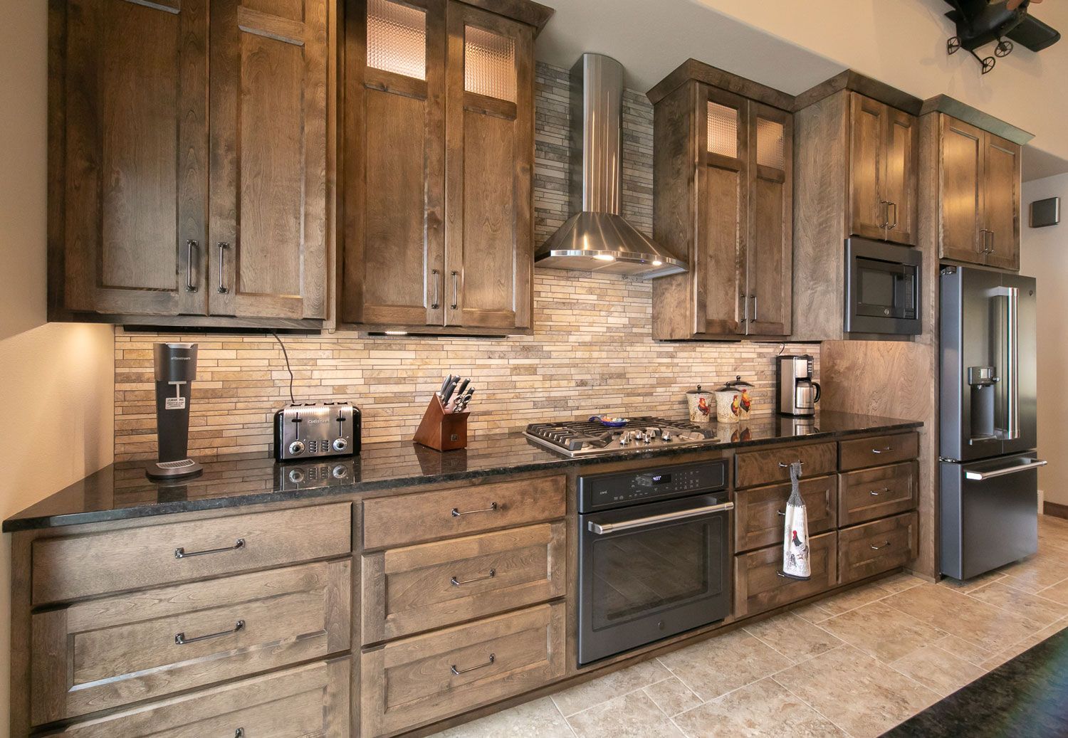 A kitchen with wooden cabinets and stainless steel appliances.
