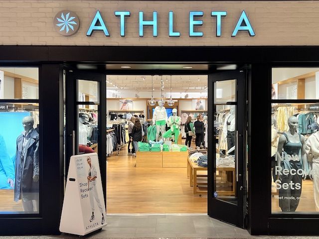 The front of an athleta store with the doors open