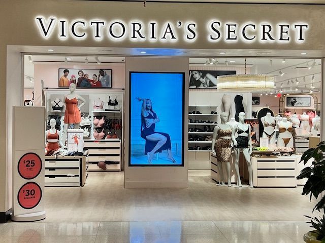A victoria 's secret store with mannequins in front of it