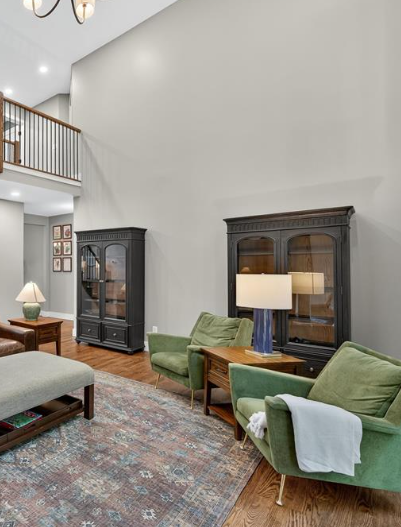 A man wearing a hard hat and goggles is standing in a room.