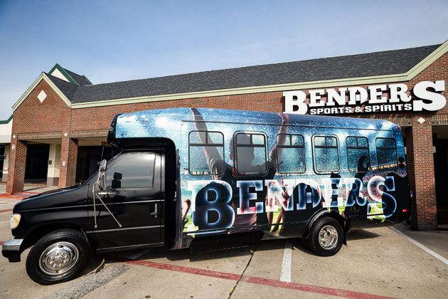 A benders truck is parked in front of a brick building