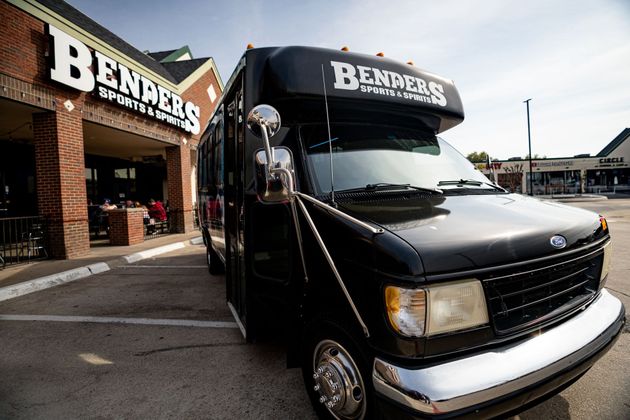 A black van is parked in front of a building that says bendiers