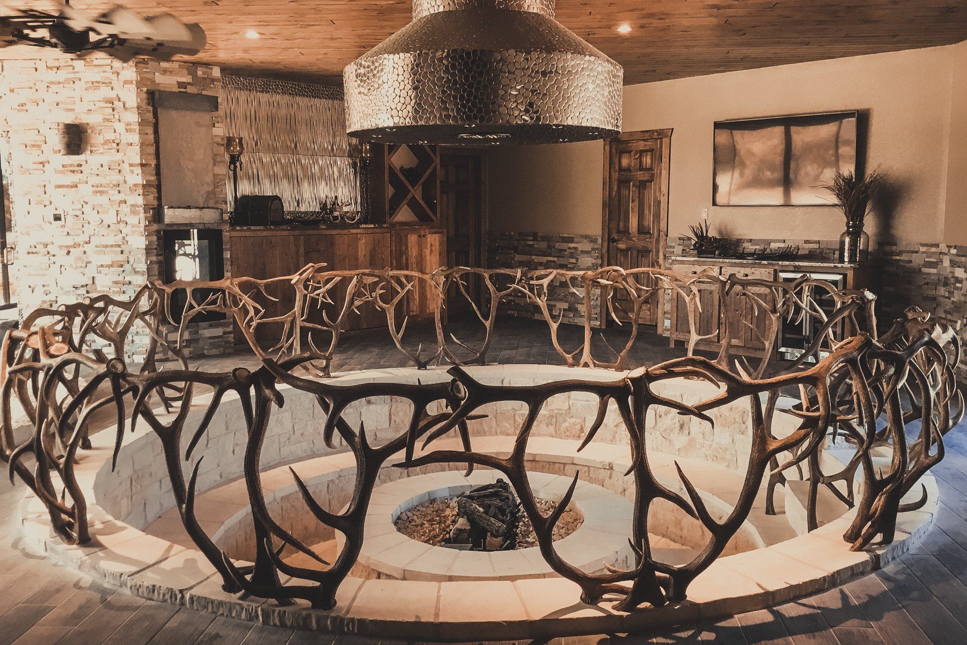 Antler railing around an indoor fire pit