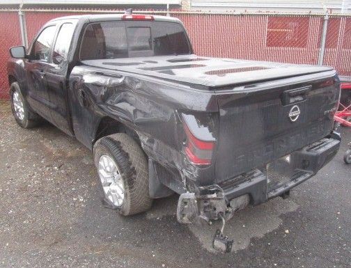 A black truck with a damaged bed is parked in a parking lot. Auto Body Repair in Colville, WA