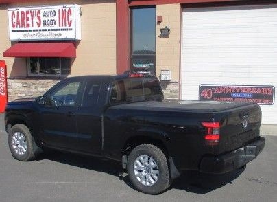 A black truck is parked in front of a building. Auto Body Repair in Colville, WA
