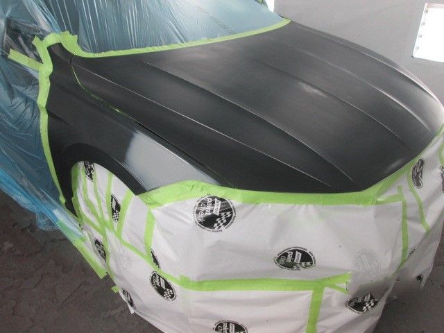 A car is covered in plastic and tape and is being painted. Auto Body Repair in Colville, WA