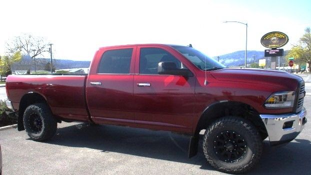 A red dodge ram truck is parked on the side of the road. Auto Body Repair in Colville, WA