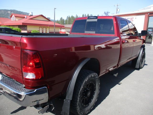 A red truck is parked in front of a building. Auto Body Repair in Colville, WA