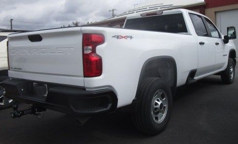 A white Chevrolet truck is parked in front of a building. Auto Body Repair in Colville, WA