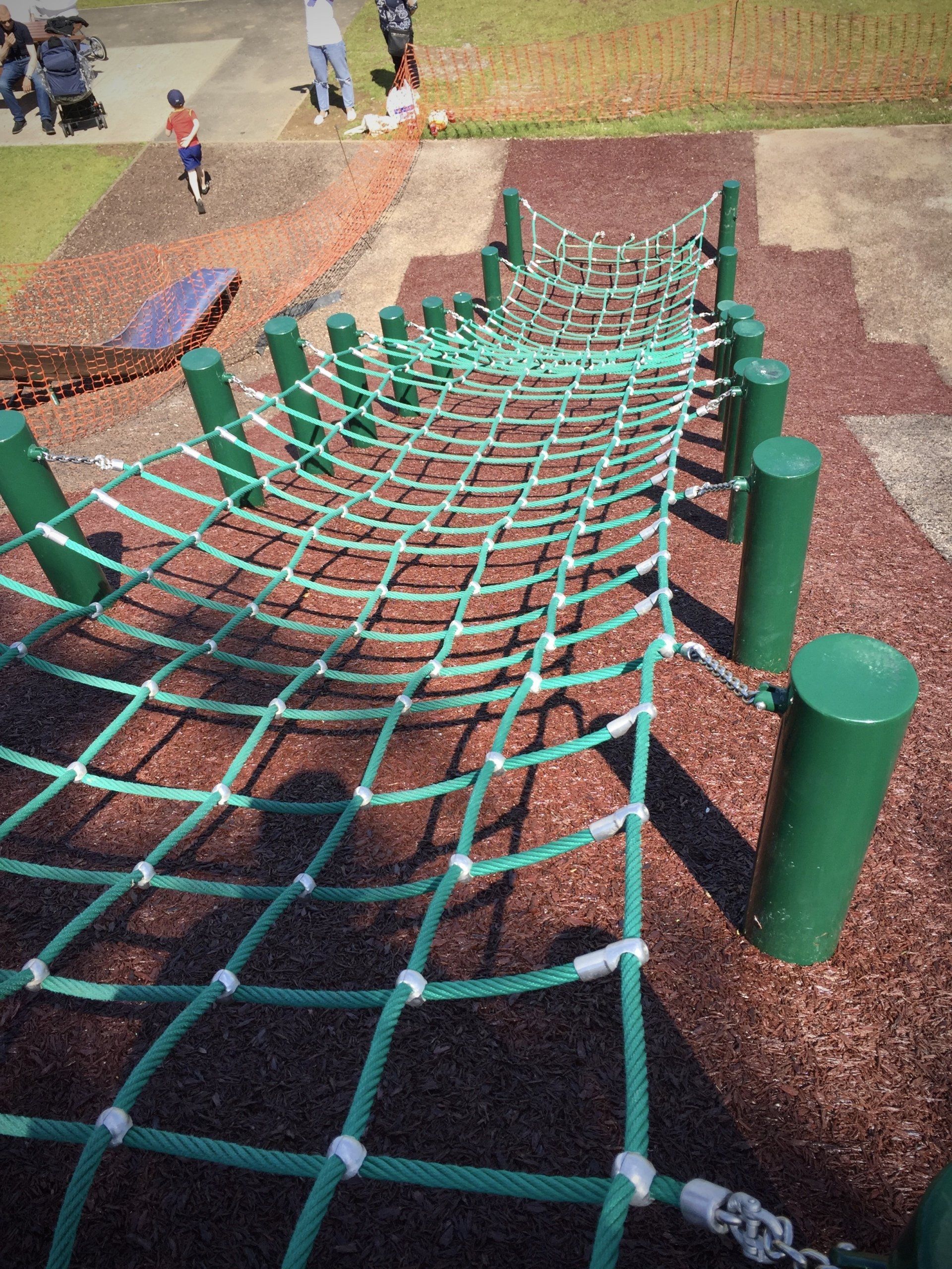 Steep play park crawl net with terracotta rubber mulch surface