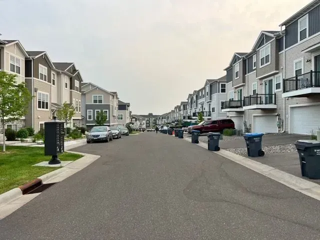 A row of houses are lined up on the side of a street.