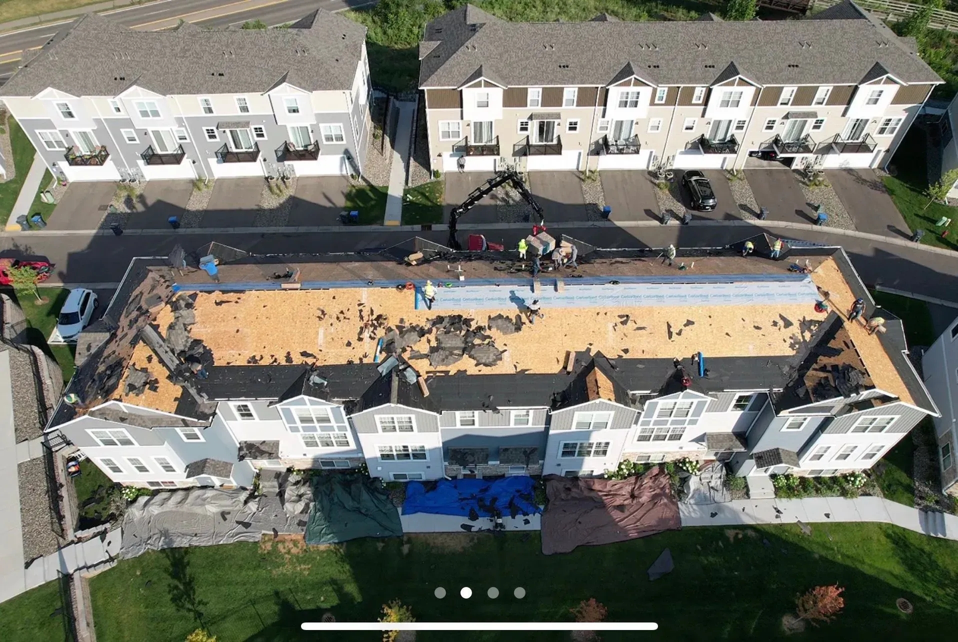 An aerial view of a roof being installed on a building.