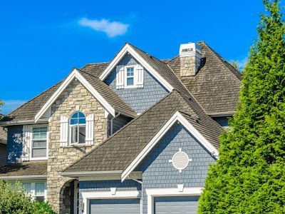 A large house with a roof that is covered in shingles.