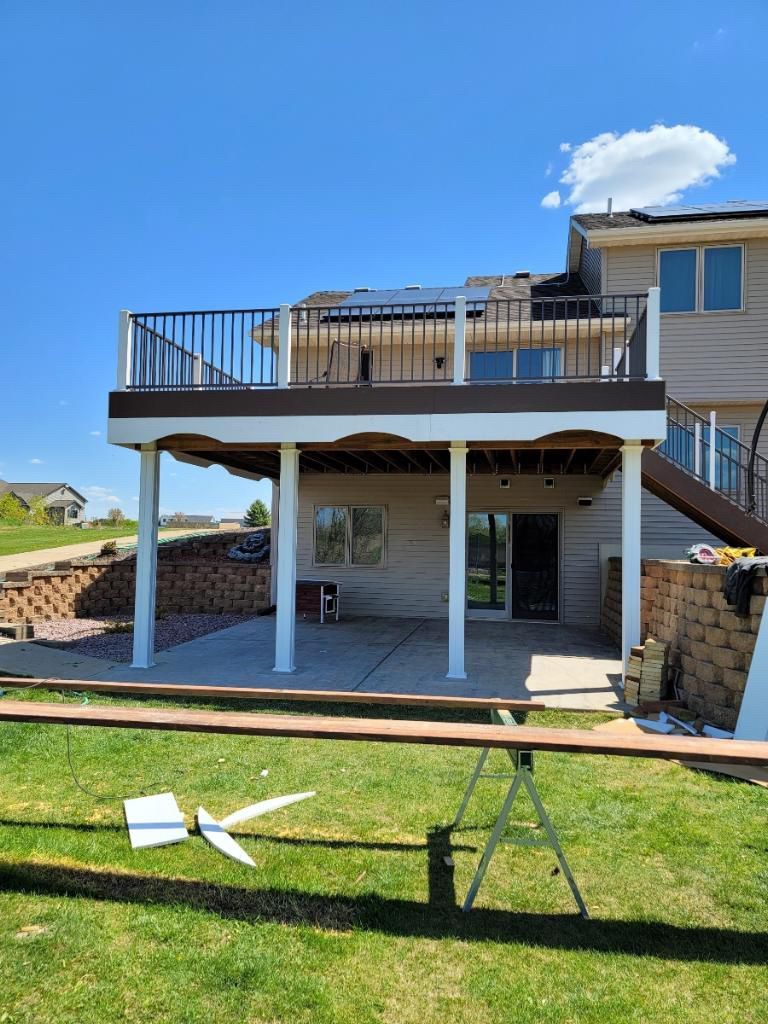 A large deck is being built on the back of a house.