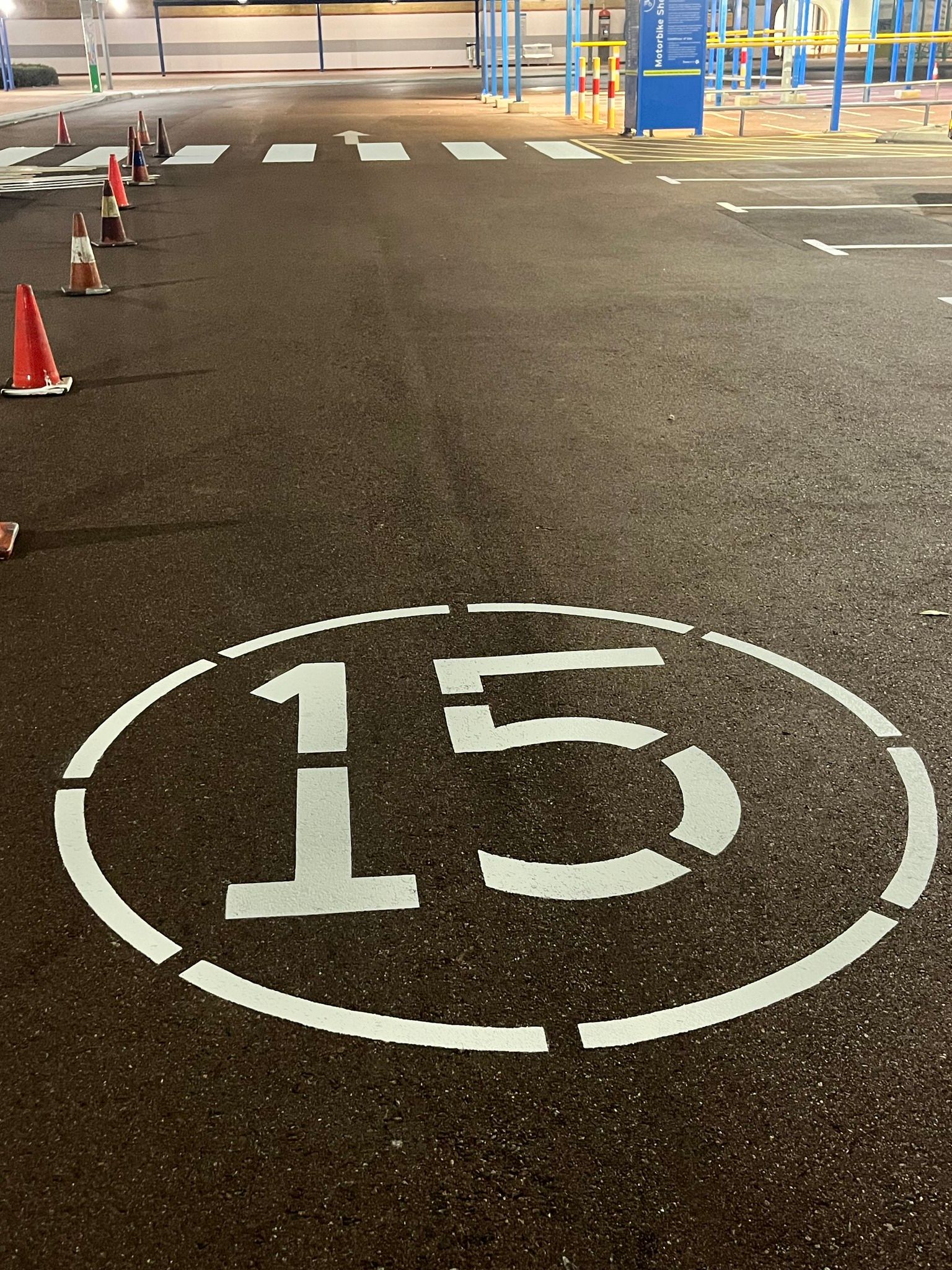 Oval marking on asphalt with the number 