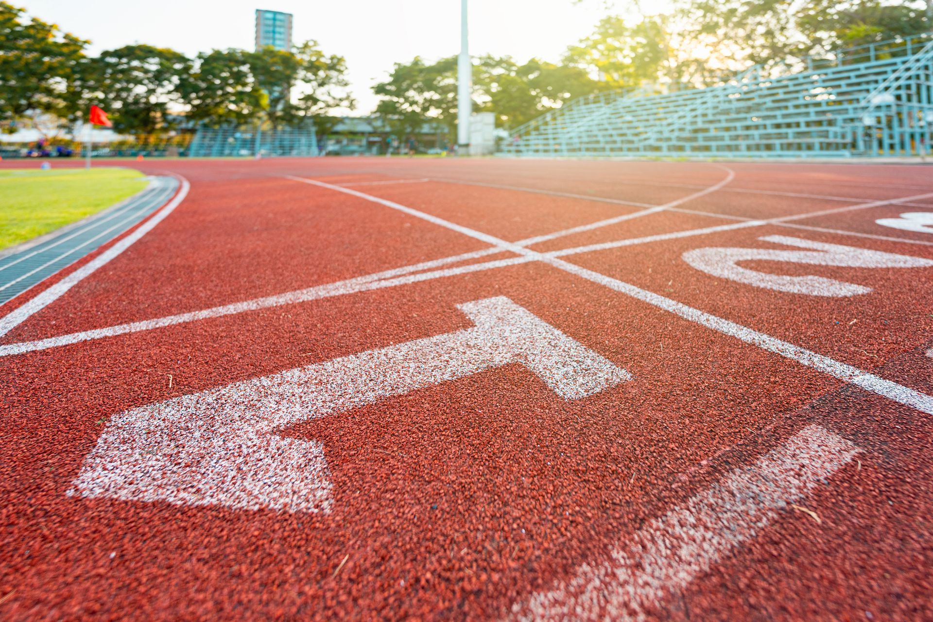Running track with lane numbers and bleachers in the background.