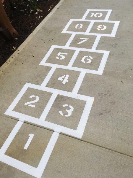 Hopscotch grid painted on concrete with numbers 1-10.