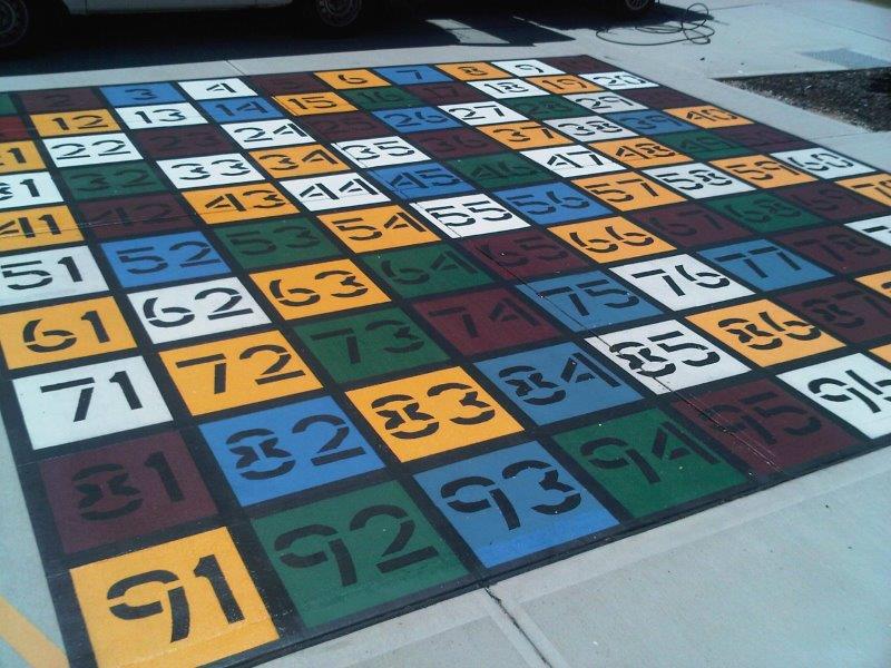 A colorful numbered grid painted on pavement, likely for a children's game.