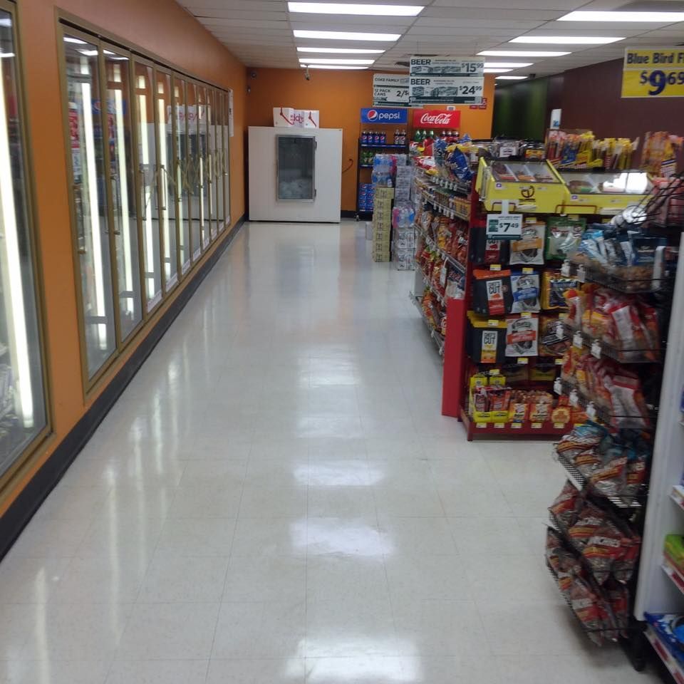 The inside of a grocery store with a pepsi machine