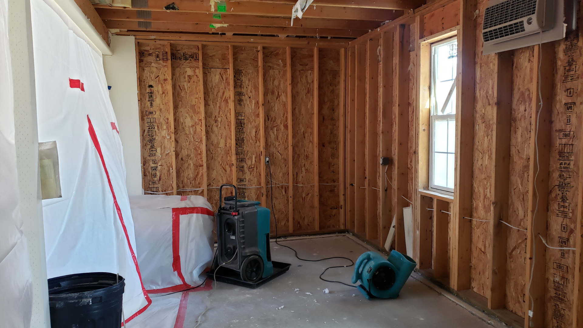 A room with a lot of wooden walls and a window.