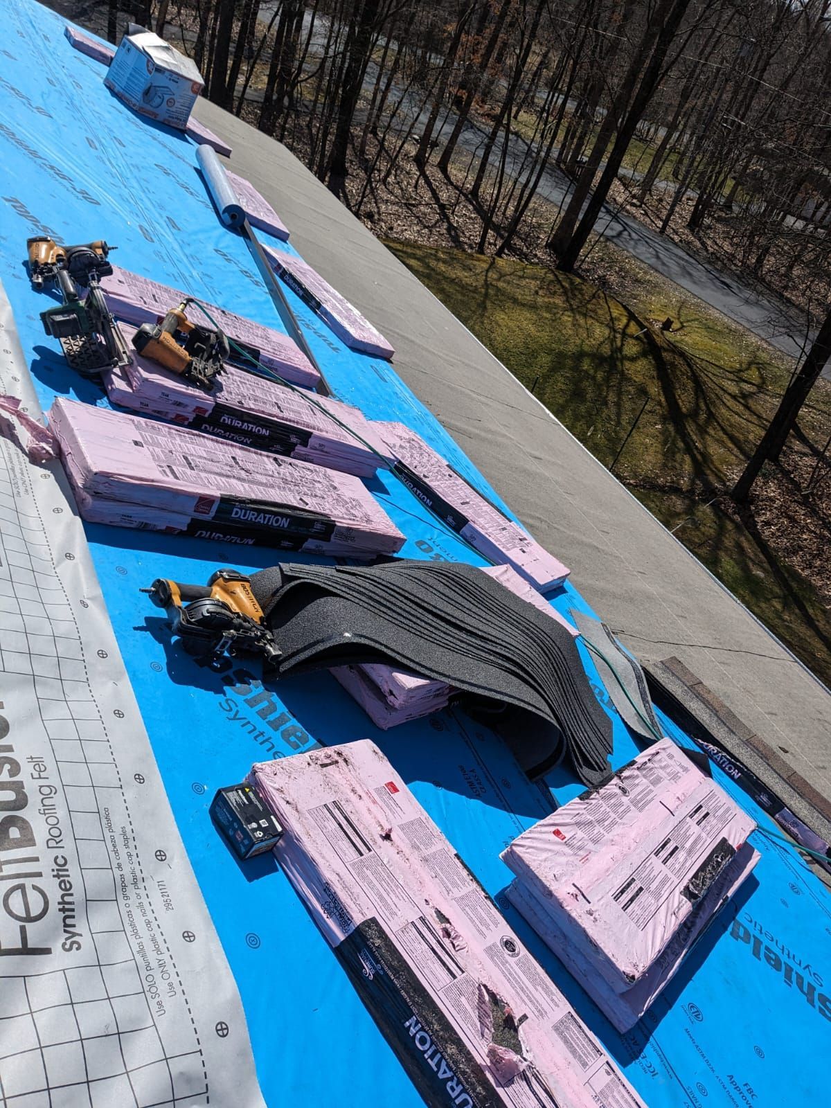 A roof is being built with a lot of tools on it.