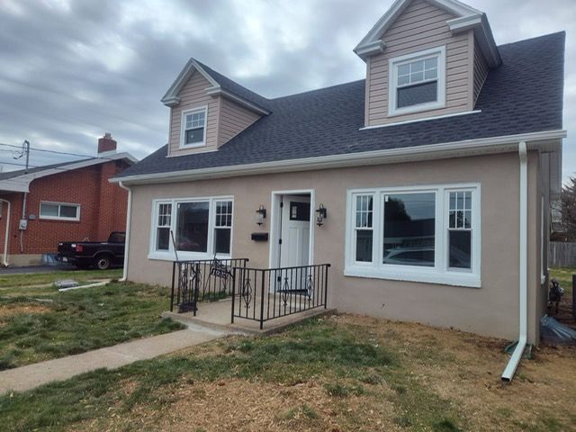 A house with a lot of windows and a black roof