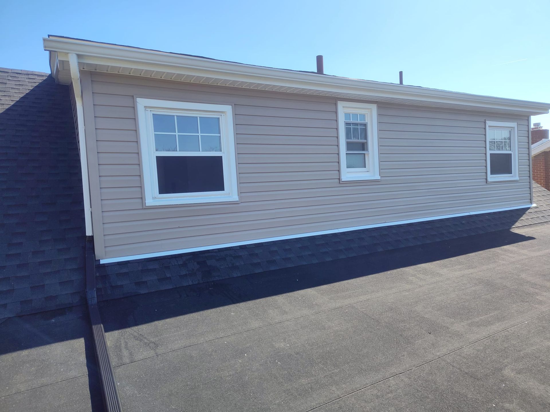 A house with a lot of windows and a roof