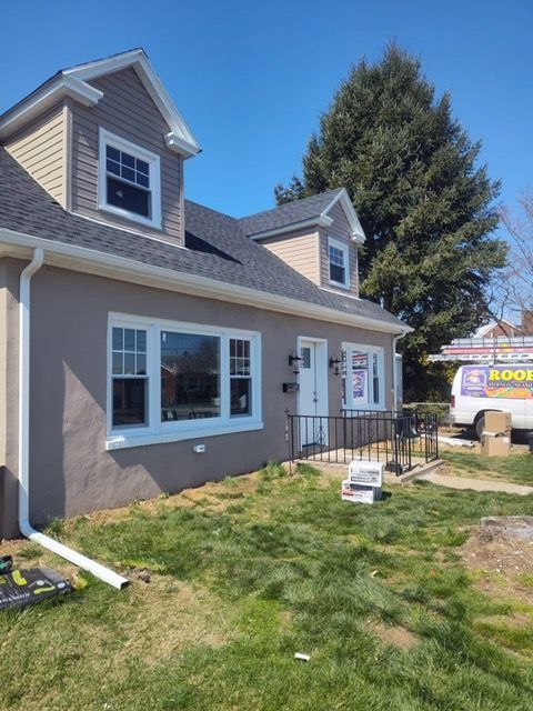 A house with a van parked in front of it that says blinds