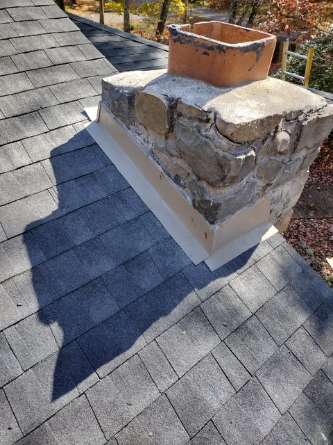 A chimney is sitting on top of a roof.