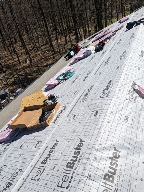A roof that has felt buster written on it
