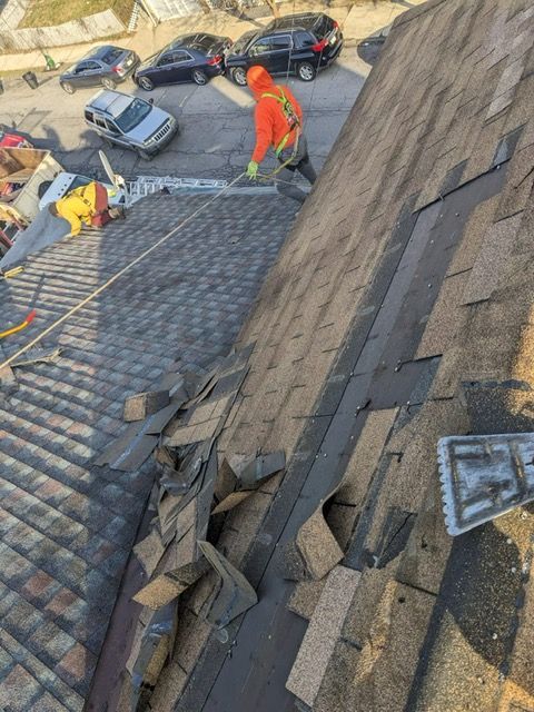 A man is working on the roof of a building.