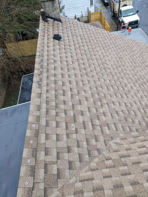 A roof with a lot of tiles and a chimney on it.