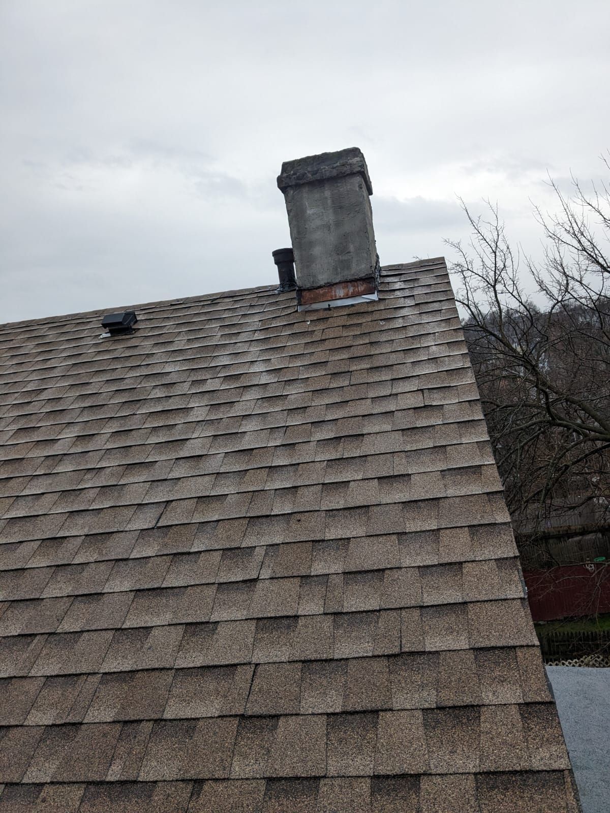 A chimney is on the roof of a house.