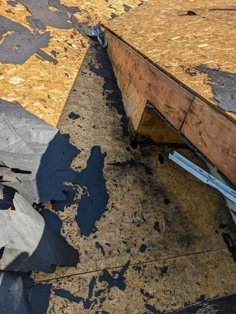 A roof with a lot of pieces of plywood on it