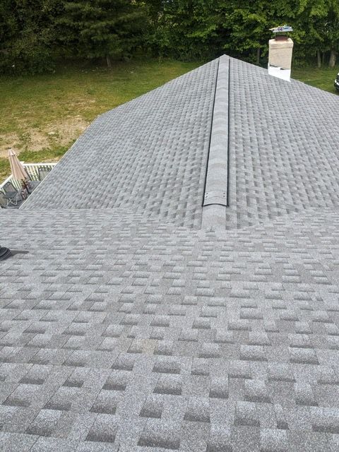 A close up of a roof with a chimney on top of it.