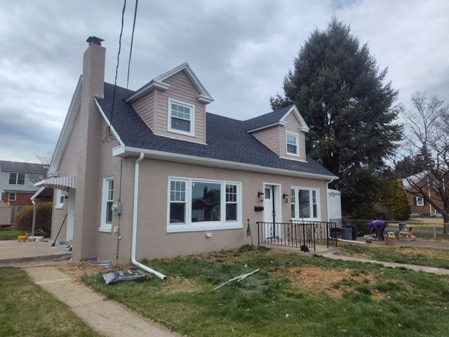 A house with a black roof and white windows