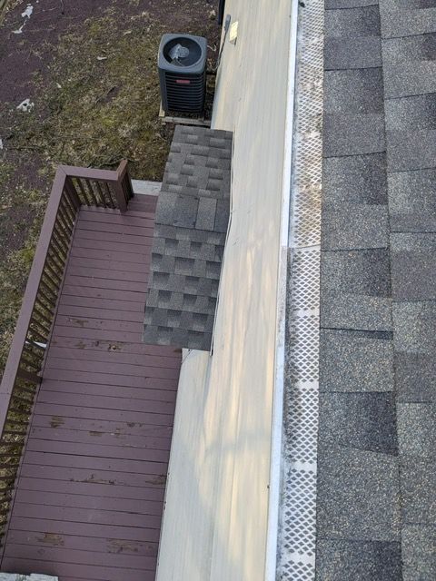 An aerial view of a house with a deck and a roof