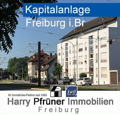 Immobilienanzeige in Freiburg: Gebäude, Straße, Straßenbahnleitungen, Logo von Harry Pfrüner Immobilien.