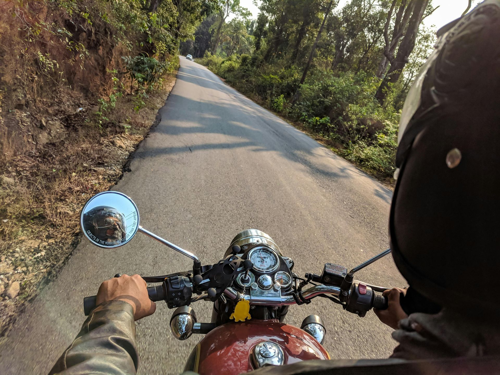 A person is riding a motorcycle down a road.