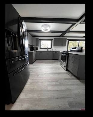 A kitchen with a refrigerator , stove , and sink.